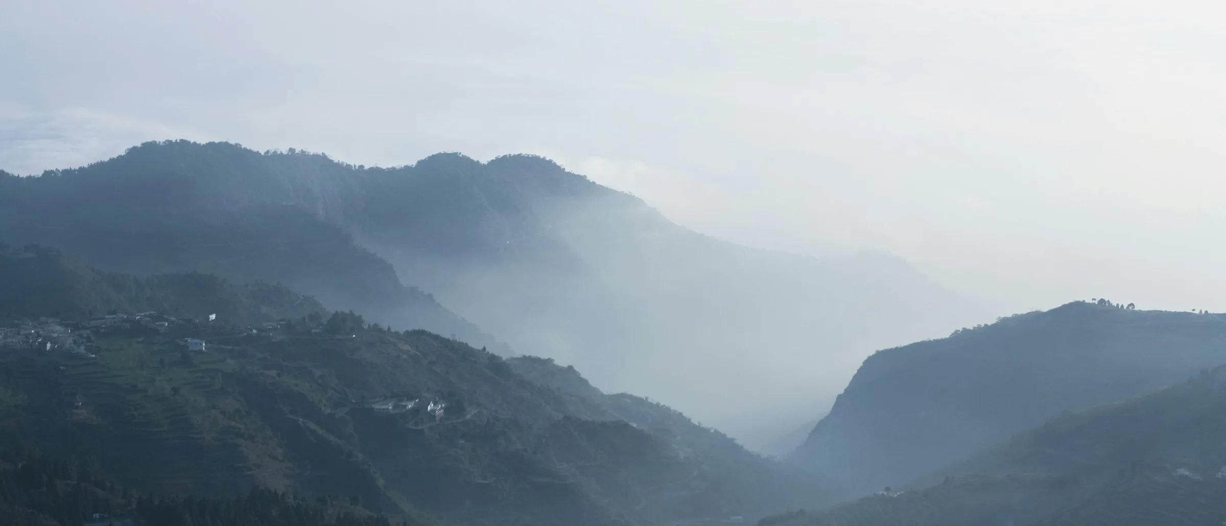 Morning haze lifting off the Dehradun foothills — the view Dynamb has shipped software under since 2019.